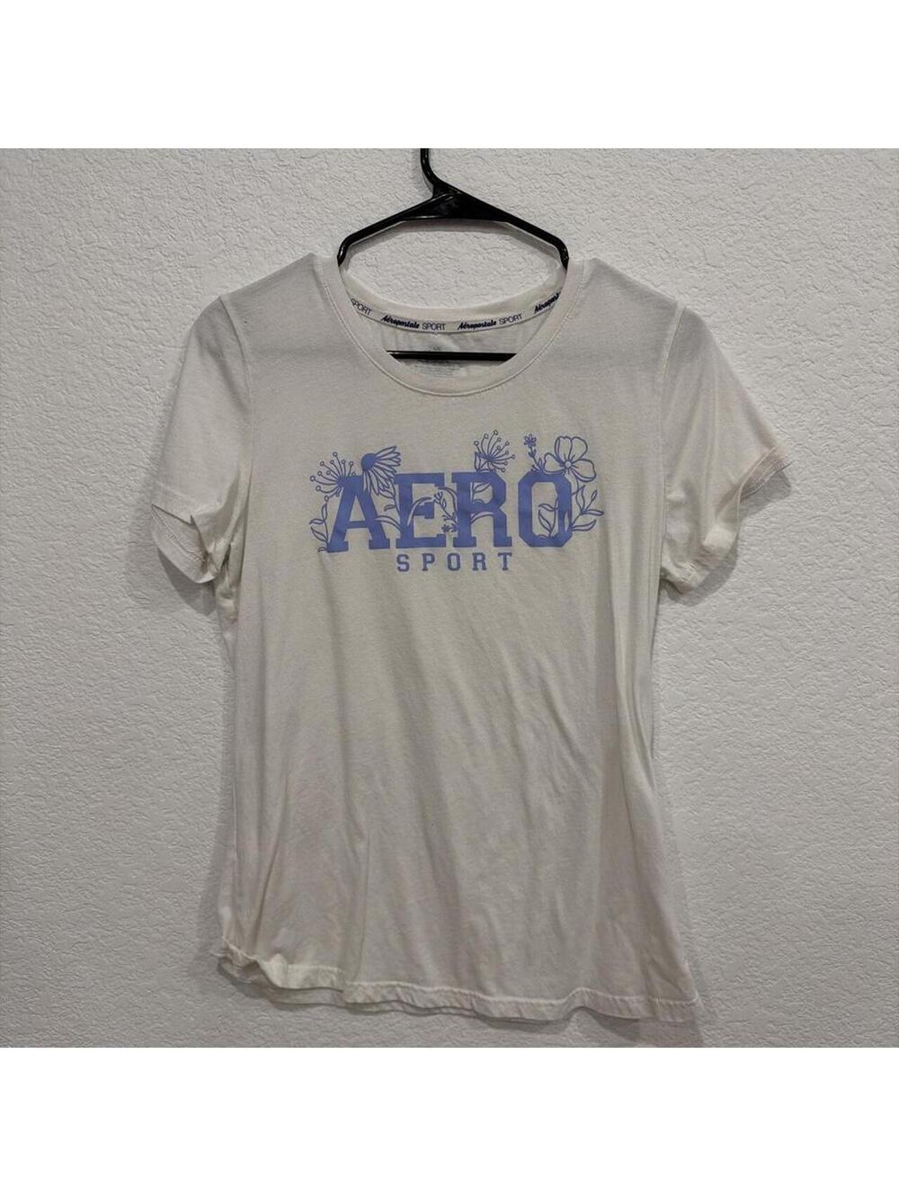 Aeropostale Aero Sport cream graphic tee with blue floral logo design.